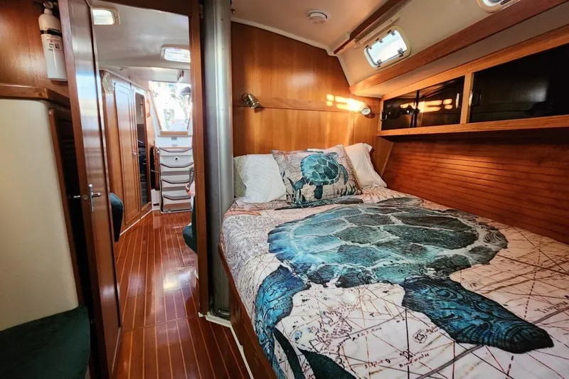 Slide: The Image of Interior of a 1998 Catalina 42 MkII sailboat with a cozy dining area. - 14