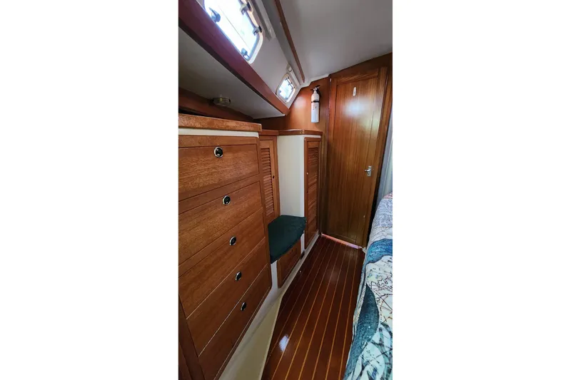 Slide: The Image of Interior of 1998 Catalina 42 MkII yacht kitchen with stove, sink, and wooden cabinetry. - 15