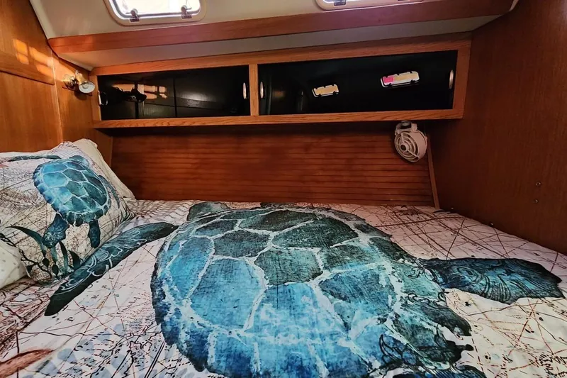 Slide: The Image of Electrical panel and storage door inside a 1998 Catalina 42 MkII sailboat cabin. - 17