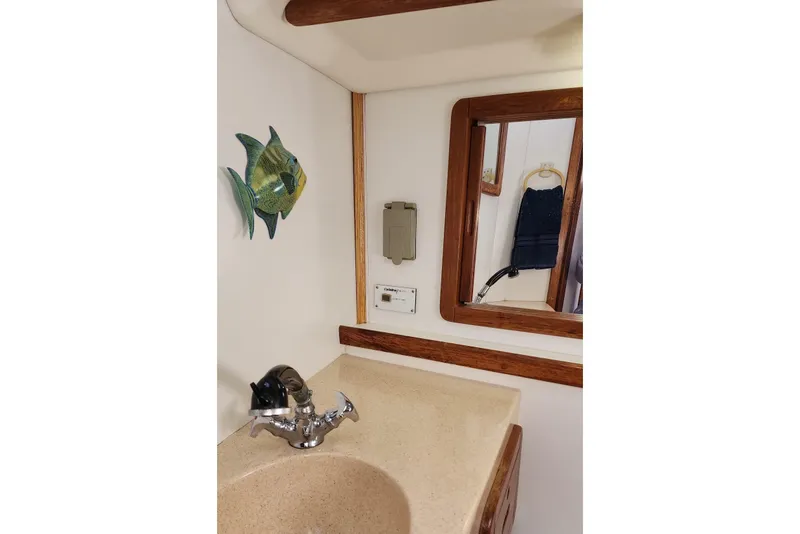 Slide: The Image of Interior of 1998 Catalina 42 MkII sailboat with wood paneling and blue seating. - 22