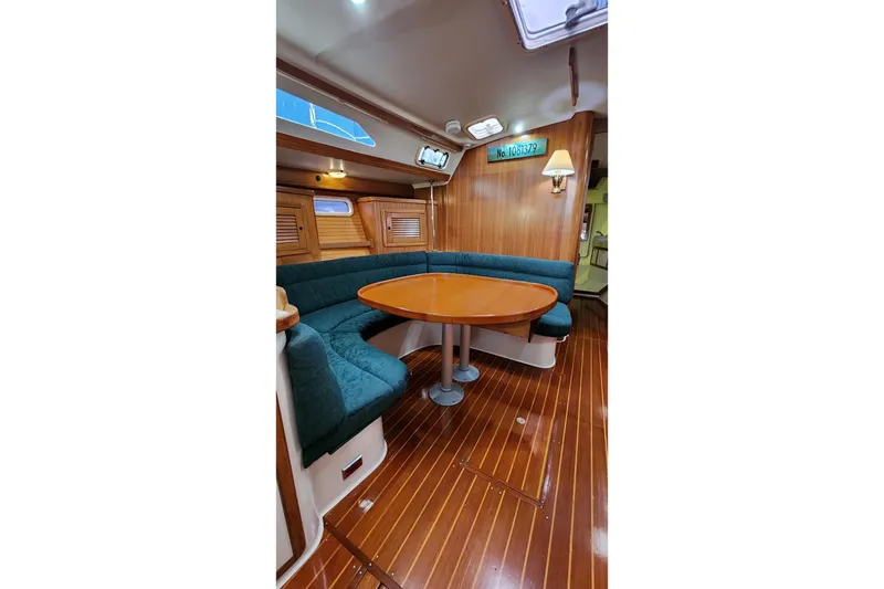 Slide: The Image of Storage compartment in a 1998 Catalina 42 MkII sailboat, featuring organized equipment and cables. - 24