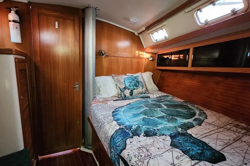 Slide: The Image of Cozy cabin interior of 1998 Catalina 42 MkII sailboat with turtle-themed bedding. - 26