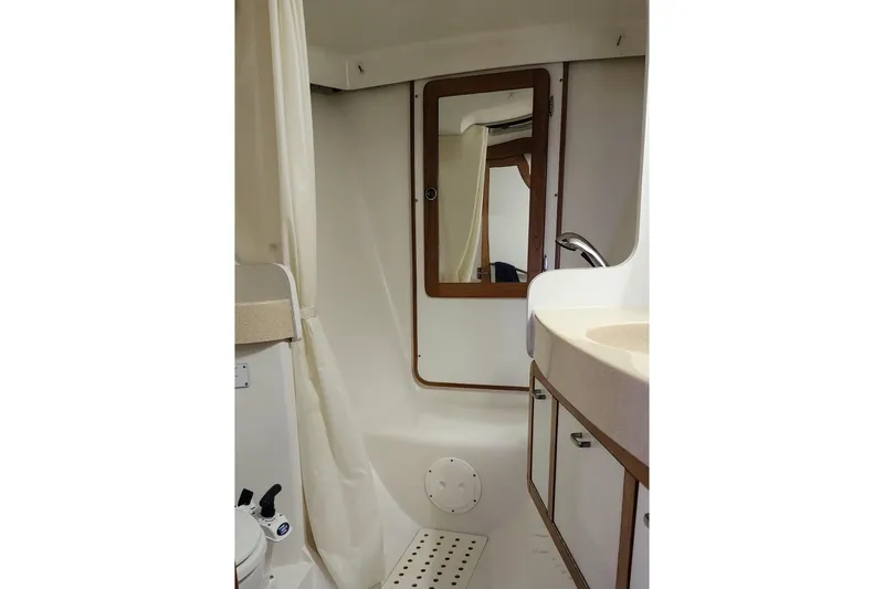 Slide: The Image of Bathroom interior of a 1998 Catalina 42 MkII sailboat, featuring a mirror and sink. - 29