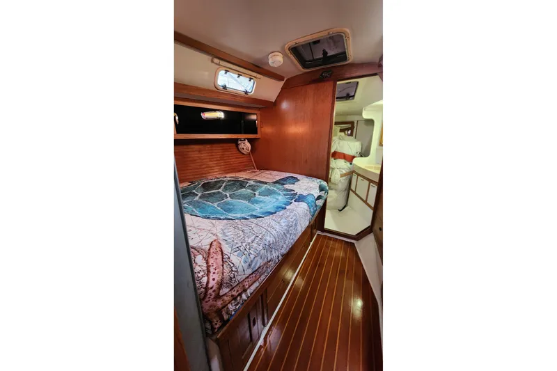 Slide: The Image of Sailboat Catalina 42 MkII, 1998 model, docked with blue canopy and clear skies. - 3