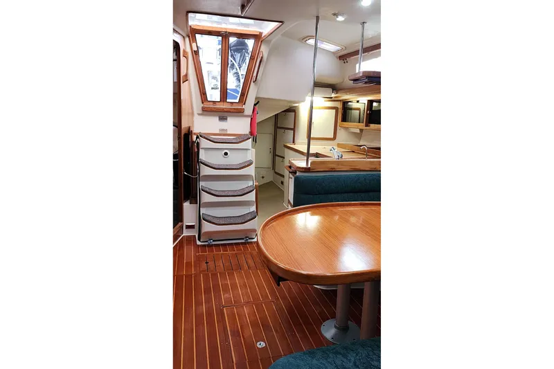 Slide: The Image of Interior of 1998 Catalina 42 MkII sailboat with wooden flooring and dining area. - 33
