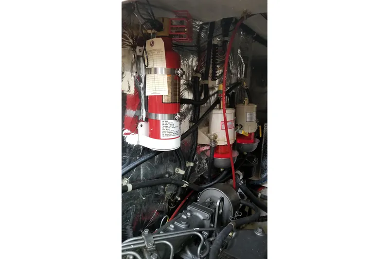 Slide: The Image of Engine compartment of a 1998 Catalina 42 MkII sailboat with fire extinguisher and fuel filters. - 35