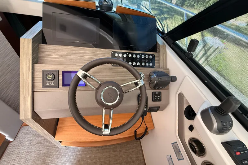 Slide: The Image of 2020 Tiara Yachts C44 Coupe helm with modern controls and comfortable seating. - 15