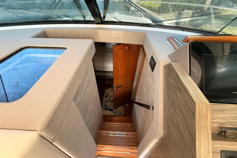 Slide: The Image of Interior helm of 2020 Tiara Yachts C44 Coupe, featuring modern controls and steering wheel. - 16