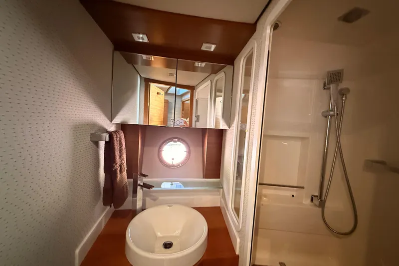 Slide: The Image of 2020 Tiara Yachts C44 Coupe helm with steering wheel and navigation controls. - 17