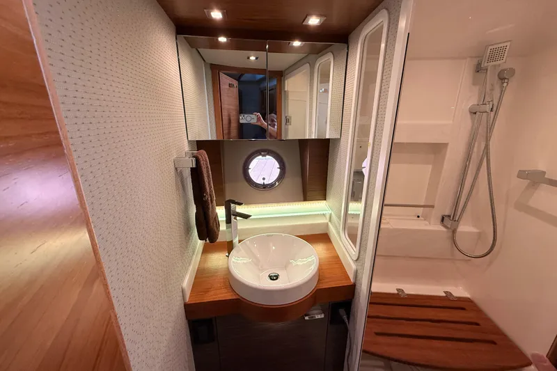 Slide: The Image of Interior view of 2020 Tiara Yachts C44 Coupe, featuring stairs and cabin entrance. - 18