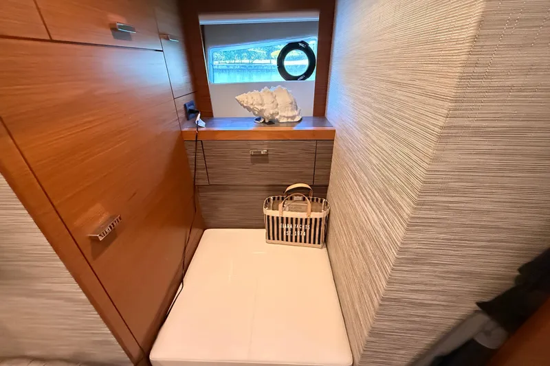 Slide: The Image of 2020 Tiara Yachts C44 Coupe cabin with twin beds and elegant decor. - 22