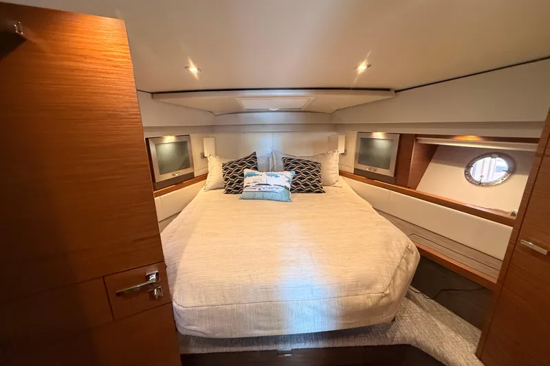 Slide: The Image of Interior view of 2020 Tiara Yachts C44 Coupe, featuring a cozy bedroom. - 25
