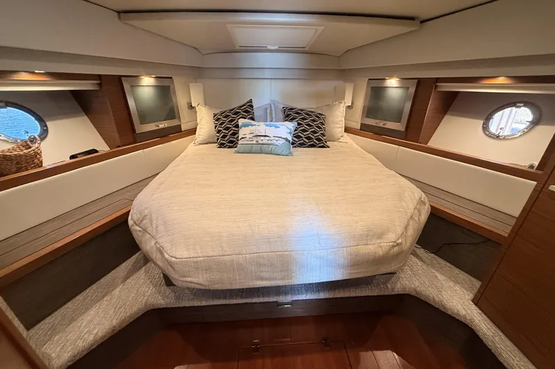 Slide: The Image of Luxurious bedroom interior of 2020 Tiara Yachts C44 Coupe with elegant wood finishes. - 26