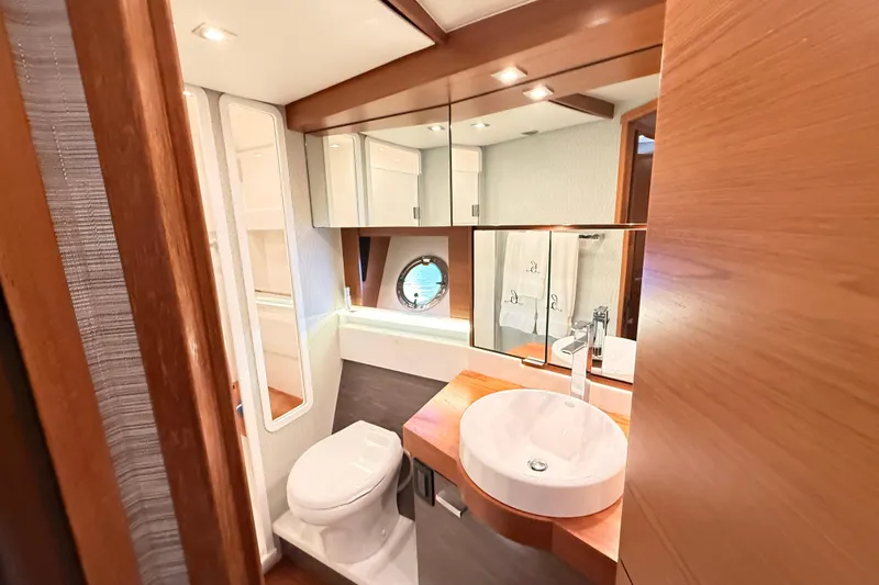 Slide: The Image of Luxurious bedroom interior of 2020 Tiara Yachts C44 Coupe with elegant bedding and lighting. - 27