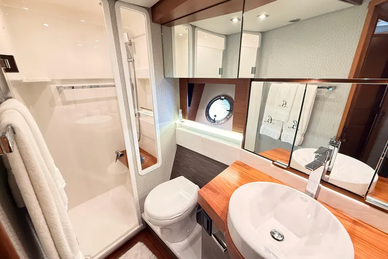 Slide: The Image of Luxurious bathroom interior of 2020 Tiara Yachts C44 Coupe with modern fixtures and wood accents. - 29