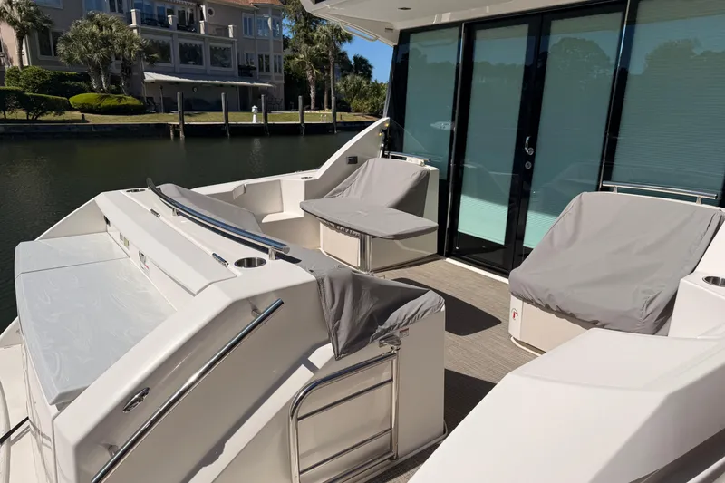 Slide: The Image of 2020 Tiara Yachts C44 Coupe docked in a scenic waterfront setting. - 3