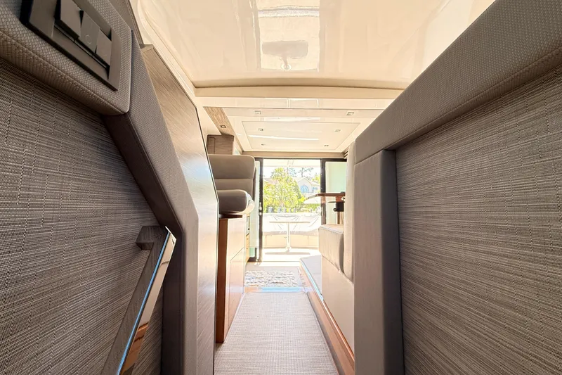 Slide: The Image of Interior of 2020 Tiara Yachts C44 Coupe, featuring wooden stairs and doors. - 33