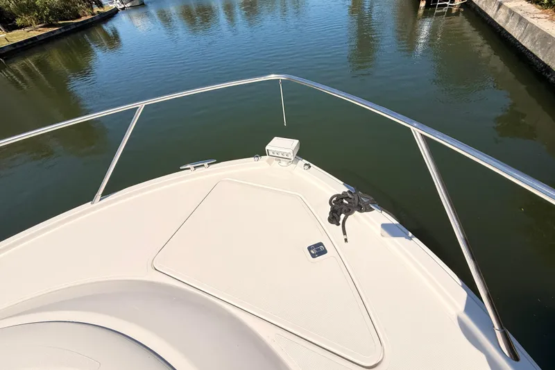 Slide: The Image of 2020 Tiara Yachts C44 Coupe on serene water, showcasing sleek design and luxurious interior. - 39