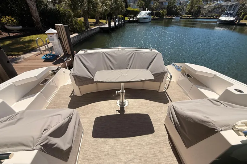 Slide: The Image of 2020 Tiara Yachts C44 Coupe docked in a serene waterfront setting. - 4