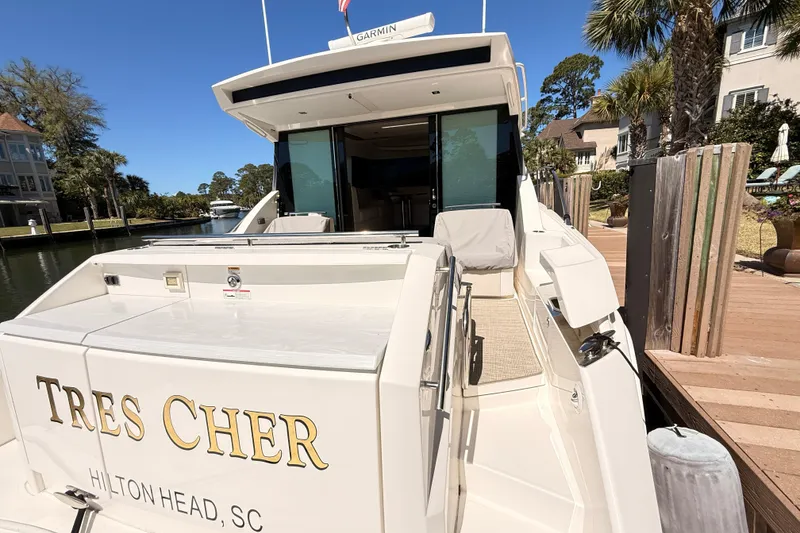 Slide: The Image of Outdoor grill on 2020 Tiara Yachts C44 Coupe, docked by a serene lake. - 50