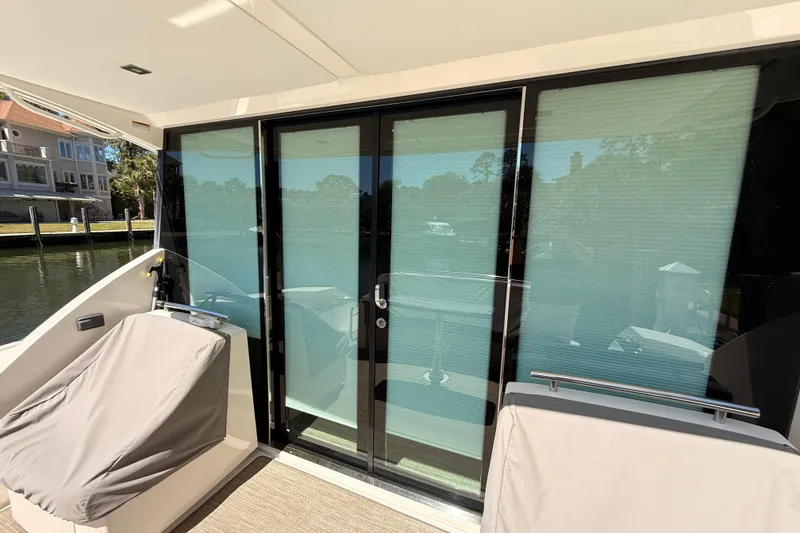 Slide: The Image of 2020 Tiara Yachts C44 Coupe yacht with covered seating and glass doors. - 59