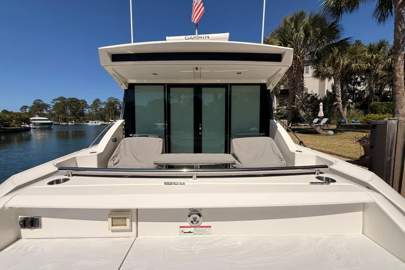 Slide: The Image of 2020 Tiara Yachts C44 Coupe docked, featuring sleek design and spacious deck area. - 60