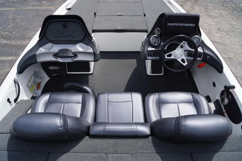 Slide: The Image of 2013 Skeeter ZX190 boat interior with steering wheel and seating, featuring Humminbird electronics. - 12