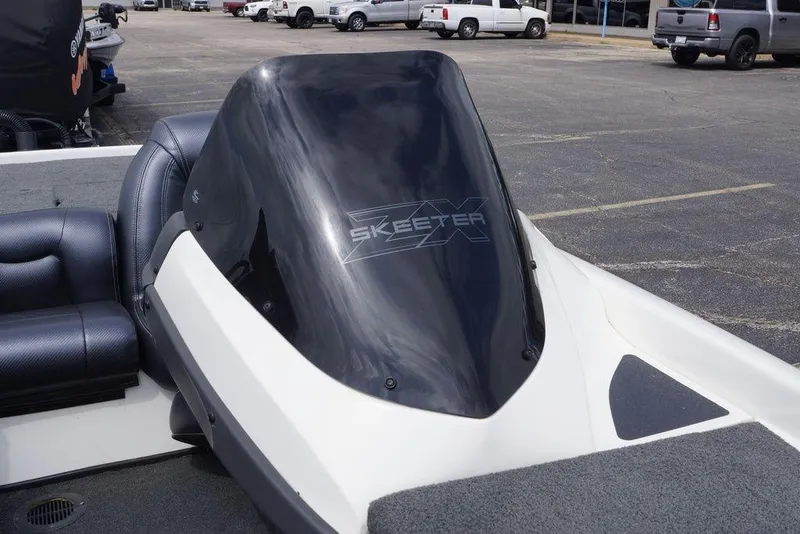 Slide: The Image of 2013 Skeeter ZX190 boat windshield and seating in a parking lot. - 15