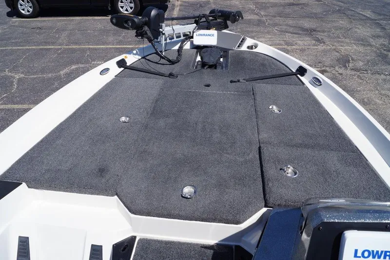 Slide: The Image of 2019 Ranger Z185 boat deck with Lowrance equipment, featuring gray carpeting and storage compartments. - 13