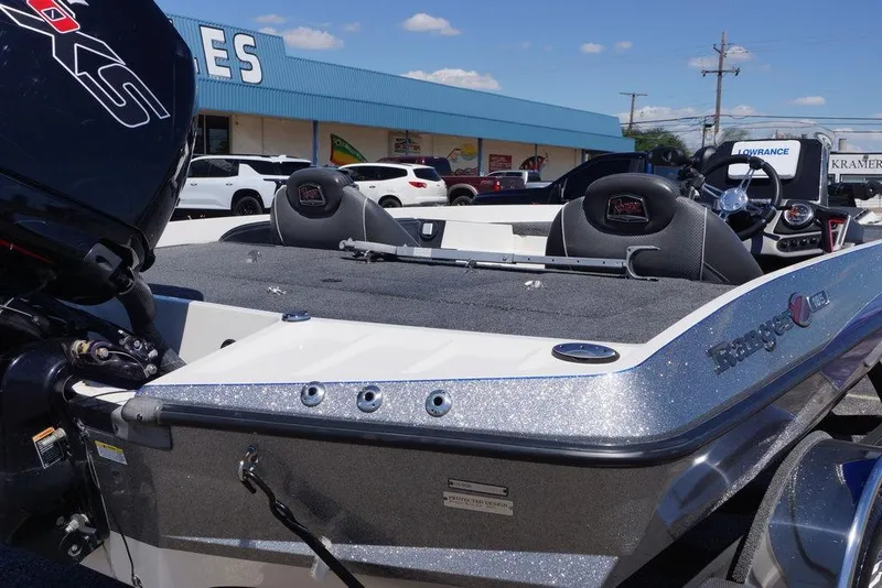 Slide: The Image of 2019 Ranger Z185 boat with motor, parked outside dealership under clear blue sky. - 21