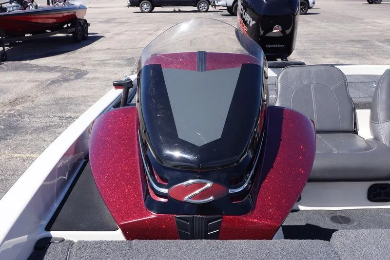 Slide: The Image of 2018 Ranger Z519 boat with sleek design and sparkling red finish in a parking lot. - 14