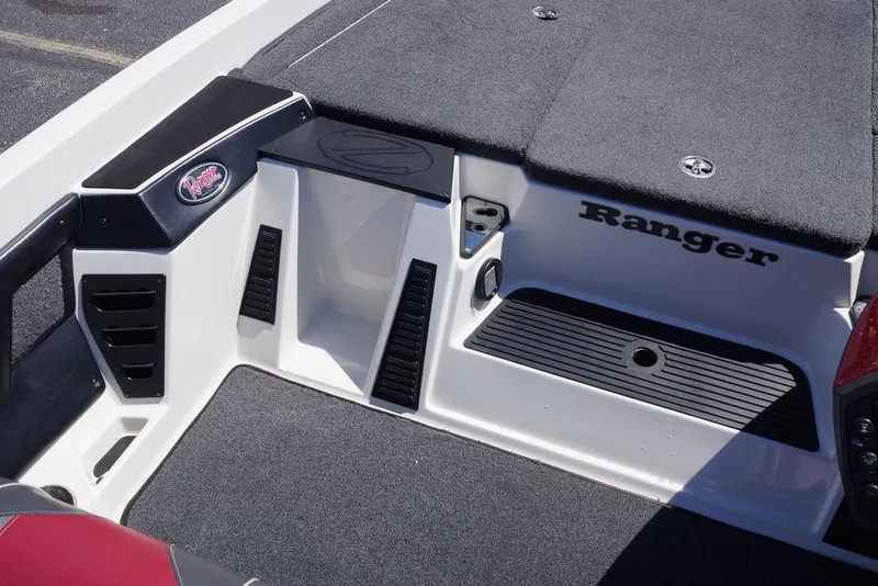 Slide: The Image of 2018 Ranger Z519 boat interior with carpeted deck and storage compartments. - 17