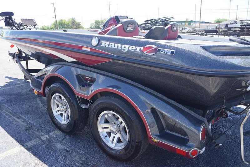 Slide: The Image of 2018 Ranger Z519 boat with dual-axle trailer, parked outdoors. - 19