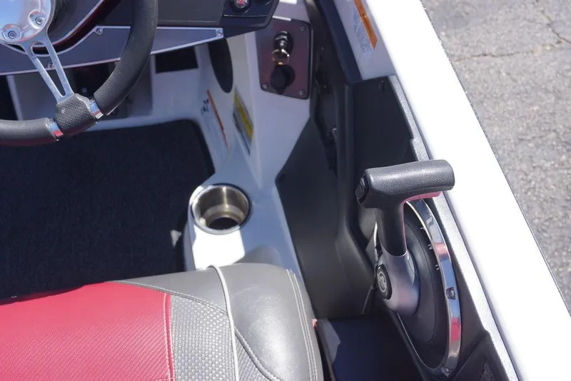 Slide: The Image of 2018 Ranger Z519 boat cockpit with steering wheel, throttle control, and cup holder. - 20
