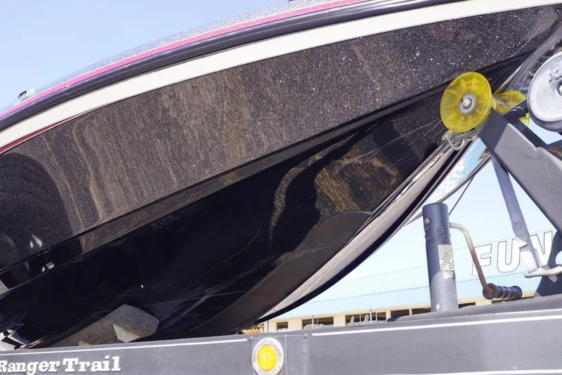 Slide: The Image of 2018 Ranger Z519 boat on trailer, close-up of hull and trailer details. - 7
