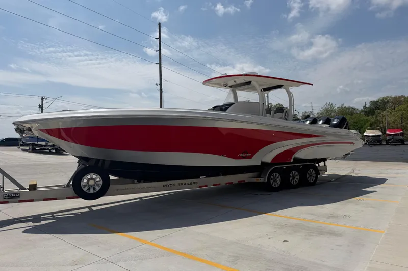 Slide: The Image of 2018 Fountain 39 NX boat on trailer, red and white design, parked outdoors. - 10