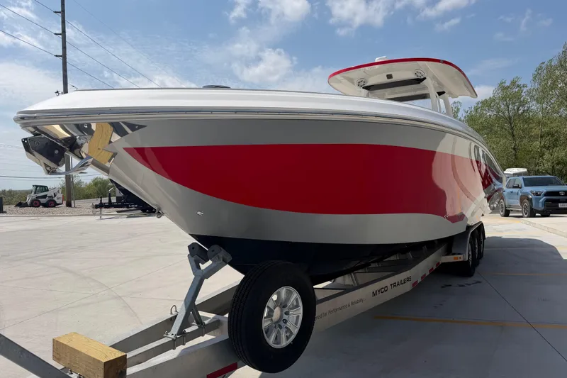 Slide: The Image of 2018 Fountain 39 NX boat with red and white design on a trailer in a parking lot. - 11