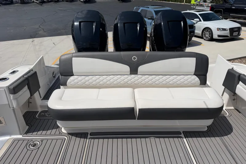 Slide: The Image of 2018 Fountain 39 NX boat with cushioned seating and triple outboard motors. - 18