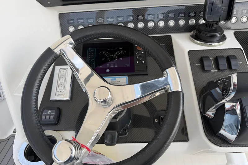 Slide: The Image of Steering wheel and dashboard of 2018 Fountain 39 NX boat, featuring modern controls. - 23