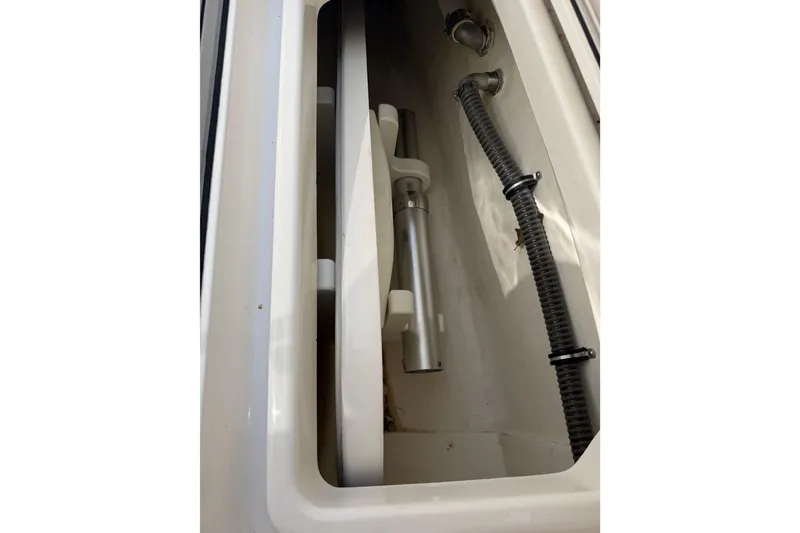 Slide: The Image of Interior view of a 2018 Fountain 39 NX boat compartment with visible pipes and fittings. - 32