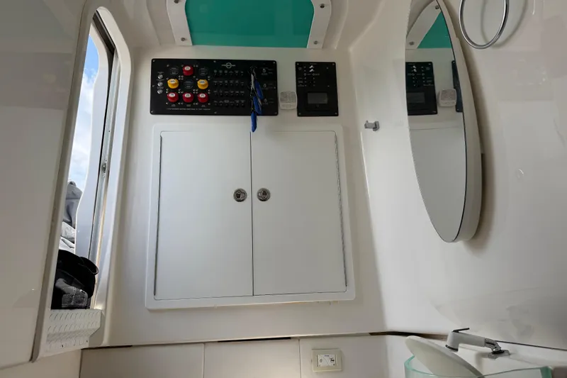 Slide: The Image of Interior of a 2018 Fountain 39 NX boat featuring control panel and mirror. - 35