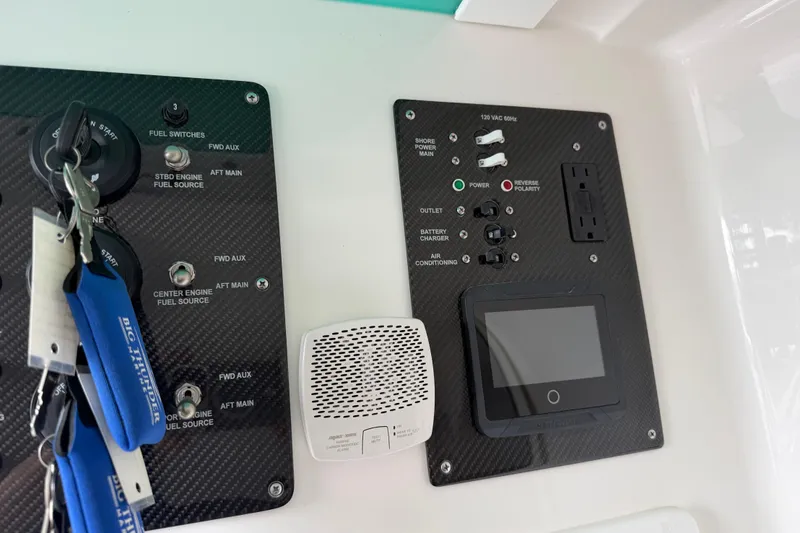 Slide: The Image of Control panel of a 2018 Fountain 39 NX boat with switches and display. - 37