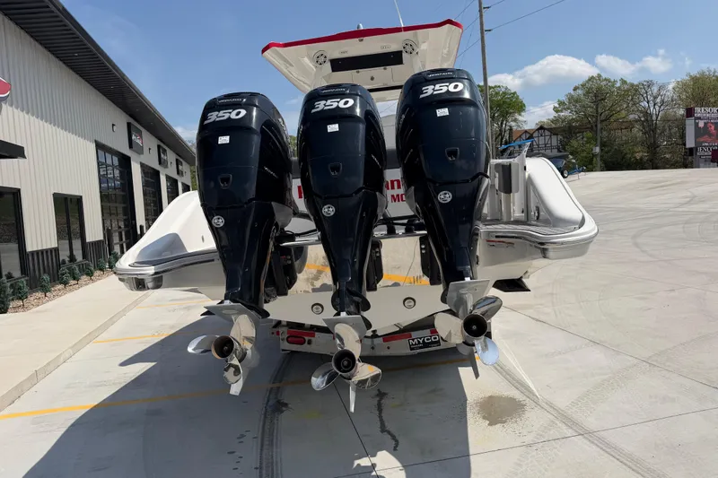 Slide: The Image of 2018 Fountain 39 NX boat with triple 350 horsepower engines, parked outside a building. - 5