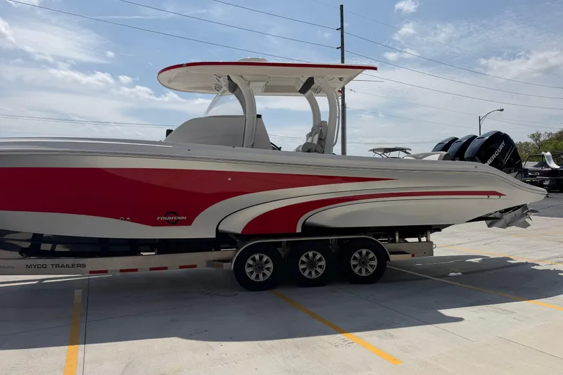 Slide: The Image of 2018 Fountain 39 NX boat with red and white design on a trailer. - 8