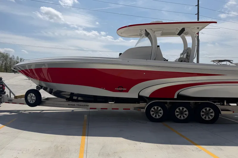 Slide: The Image of 2018 Fountain 39 NX boat on trailer, red and white design, parked outdoors. - 9