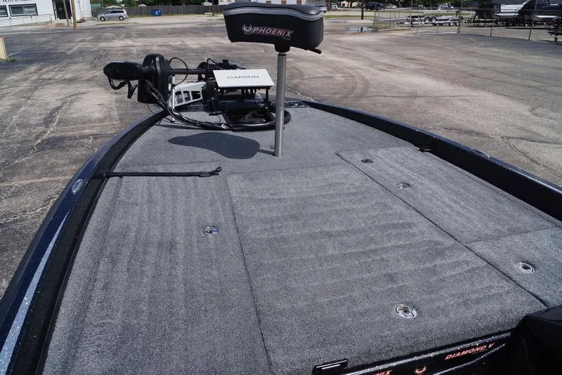 Slide: The Image of 2026 Phoenix 921 Elite X boat deck with Garmin equipment, parked outdoors. - 15