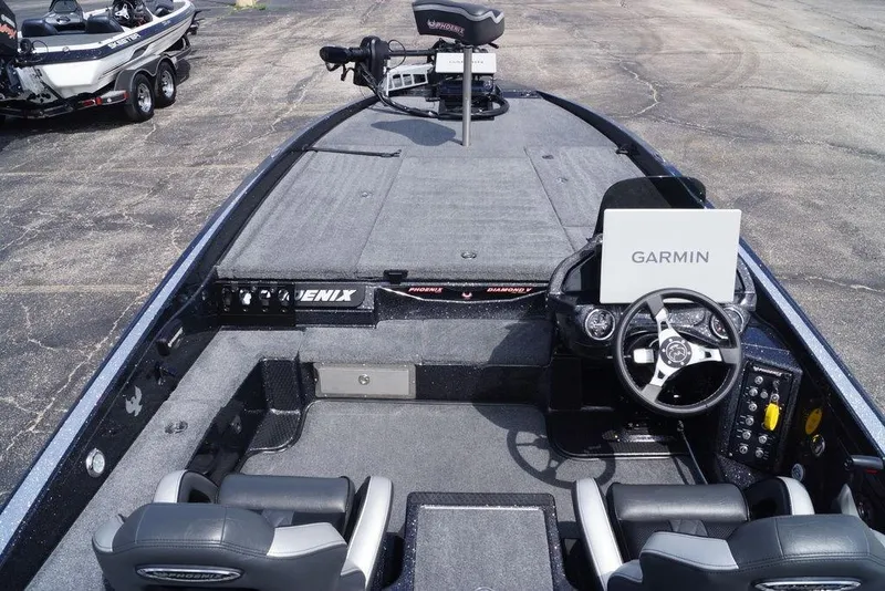 Slide: The Image of 2026 Phoenix 921 Elite X boat interior with Garmin navigation system and dual seating. - 19