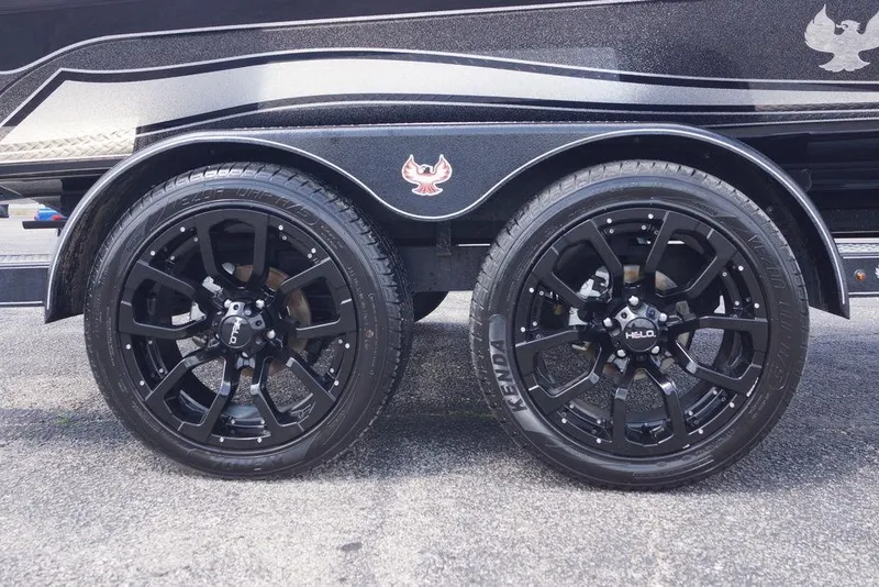 Slide: The Image of Black wheels on a 2026 Phoenix 921 Elite X trailer, featuring Helo rims and Kenda tires. - 3