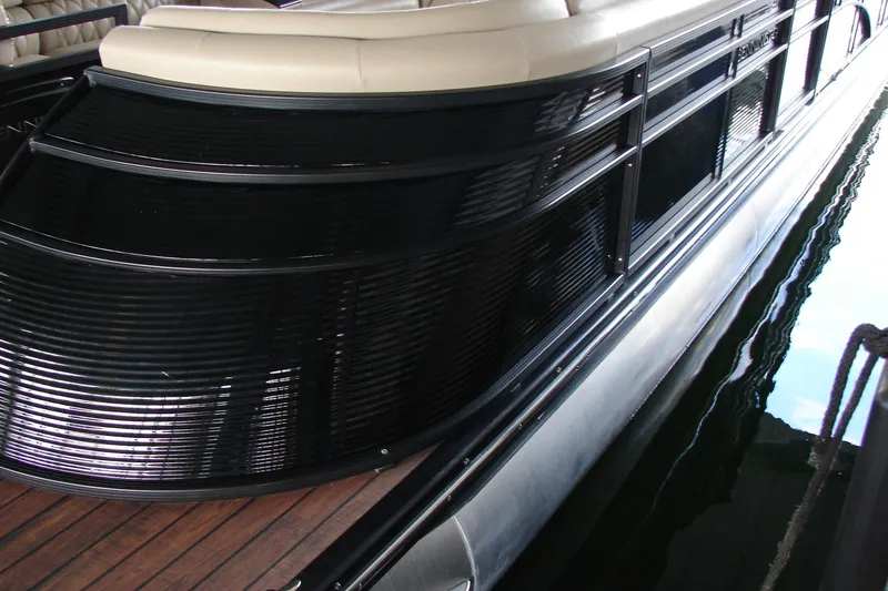 Slide: The Image of 2015 Bennington 2875 QCW I/O pontoon boat with sleek black exterior and wooden deck. - 11