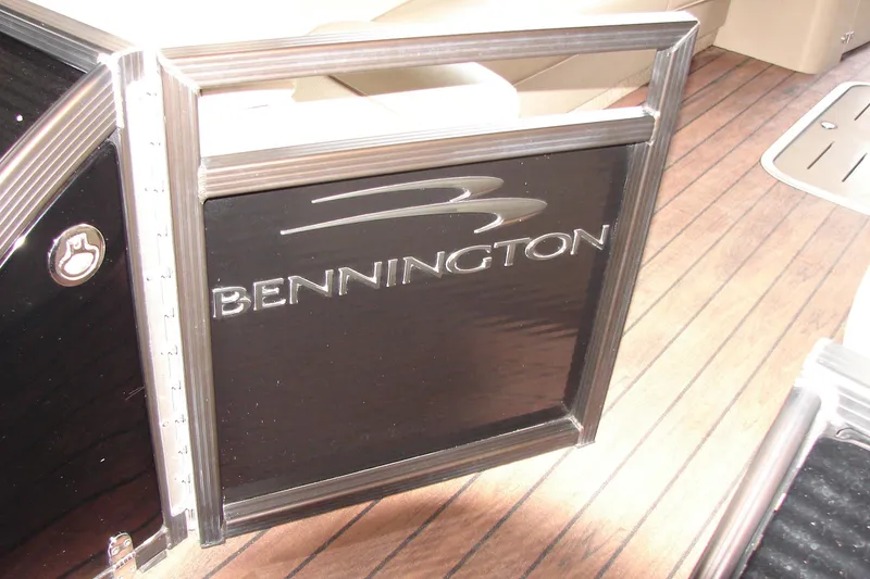 Slide: The Image of 2015 Bennington 2875 QCW I/O boat interior with branded gate and wood flooring. - 12